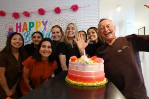 a smiling group with a cake