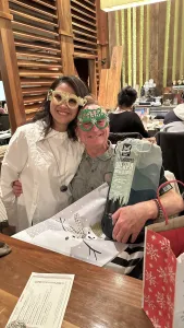 a man and woman sitting side by side and smiling
